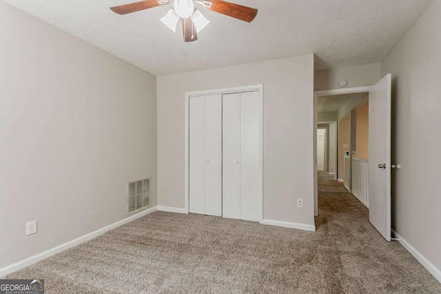 1074 Cherokee Hts, Stone Mountain, GA 30083 - unfurnished bedroom featuring carpet floors, a closet, a textured ceiling, and ceiling fan