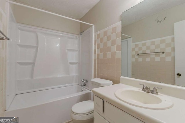 1074 Cherokee Hts, Stone Mountain, GA 30083 - full bath with vanity, tile walls, shower / washtub combination, and a textured ceiling