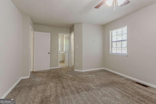 1074 Cherokee Hts, Stone Mountain, GA 30083 - unfurnished room featuring a ceiling fan, carpet floors, and a textured ceiling