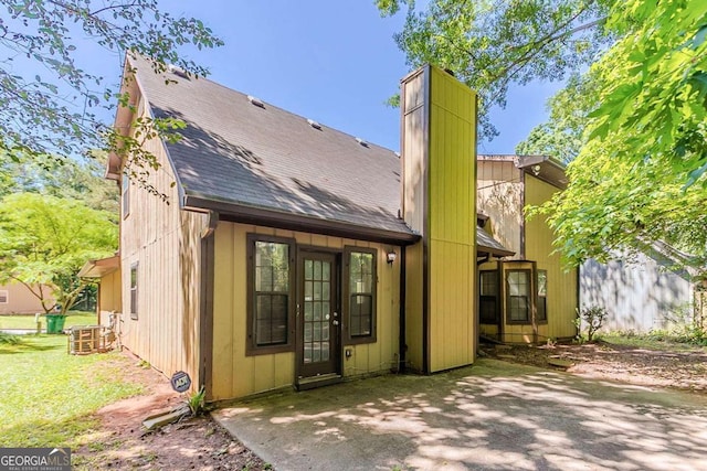 1074 Cherokee Hts, Stone Mountain, GA 30083 - rear view of property with a shingled roof, a patio area, and a chimney