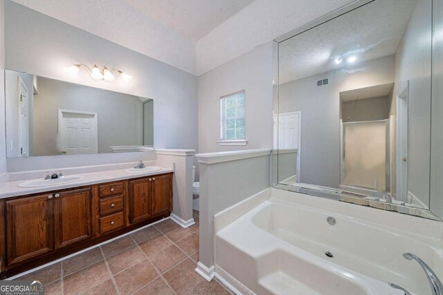 12237 Cypress Ln, Fayetteville, GA 30215 - bathroom featuring a bath, double vanity, baseboards, toilet, and a textured ceiling