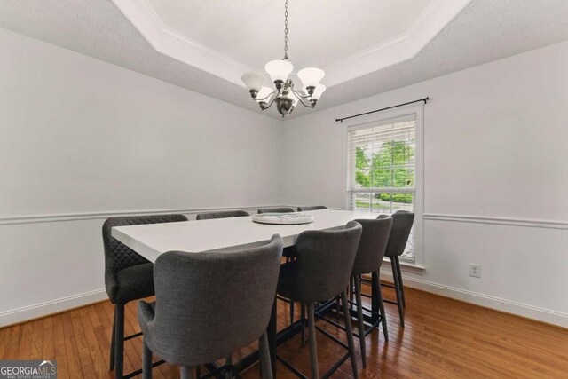418 Whisper Wood Way, Locust Grove, GA 30248 - dining space with a chandelier, a raised ceiling, and baseboards