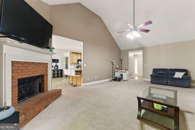 418 Whisper Wood Way, Locust Grove, GA 30248 - living area featuring light carpet, a ceiling fan, high vaulted ceiling, a brick fireplace, and baseboards