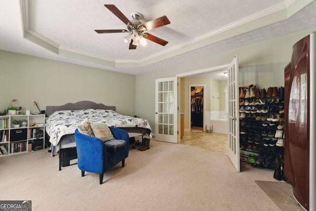418 Whisper Wood Way, Locust Grove, GA 30248 - carpeted bedroom with crown molding, a tray ceiling, french doors, ceiling fan, and a walk in closet