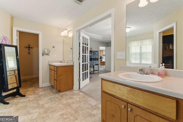 418 Whisper Wood Way, Locust Grove, GA 30248 - full bath featuring two vanities and baseboards