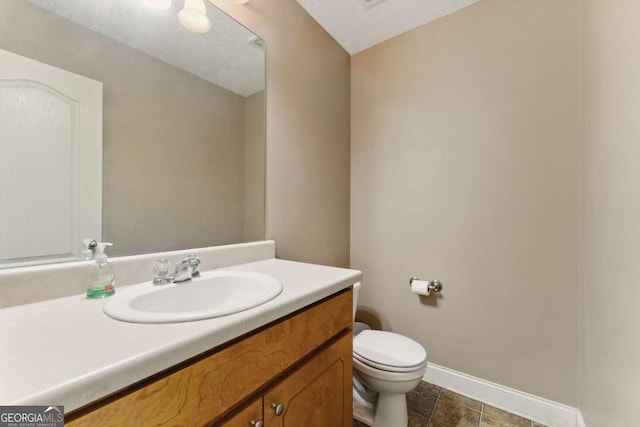 418 Whisper Wood Way, Locust Grove, GA 30248 - bathroom featuring baseboards, toilet, and vanity