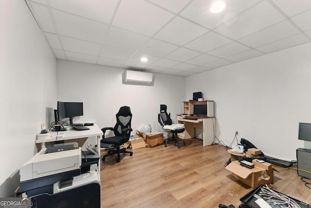 418 Whisper Wood Way, Locust Grove, GA 30248 - home office with a drop ceiling, light wood-type flooring, and a wall mounted air conditioner