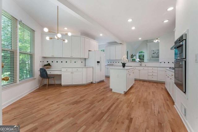 1575 Wynridge Pointe, Alpharetta, GA 30005 - kitchen with white refrigerator with ice dispenser, light countertops, white cabinets, and recessed lighting