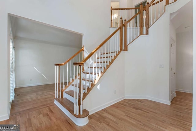 1575 Wynridge Pointe, Alpharetta, GA 30005 - staircase with wood finished floors, baseboards, and a towering ceiling