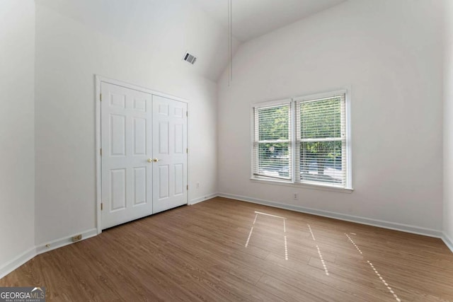 1575 Wynridge Pointe, Alpharetta, GA 30005 - unfurnished bedroom featuring wood finished floors, baseboards, and lofted ceiling