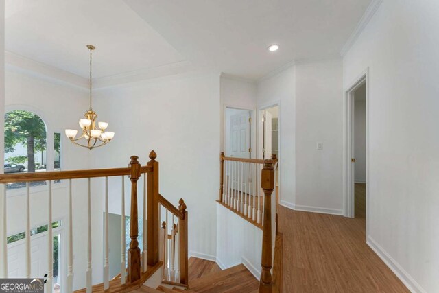 1575 Wynridge Pointe, Alpharetta, GA 30005 - hall with an upstairs landing, wood finished floors, a chandelier, baseboards, and ornamental molding