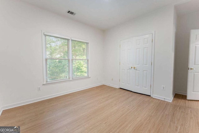 1575 Wynridge Pointe, Alpharetta, GA 30005 - unfurnished bedroom featuring light wood finished floors and baseboards