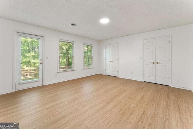 1575 Wynridge Pointe, Alpharetta, GA 30005 - unfurnished living room with healthy amount of natural light and light wood-style flooring