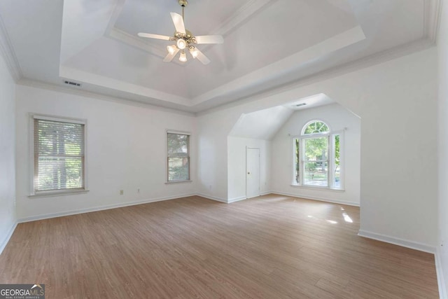 additional living space featuring wood finished floors, baseboards, and a ceiling fan