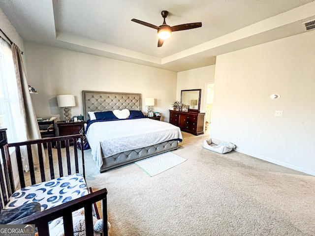 7860 Bristol Valley Dr, Cumming, GA 30028 - carpeted bedroom featuring a raised ceiling, baseboards, and ceiling fan