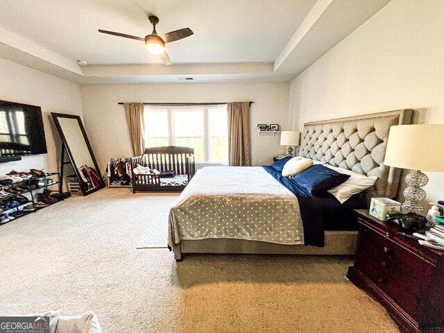 7860 Bristol Valley Dr, Cumming, GA 30028 - carpeted bedroom featuring a raised ceiling and ceiling fan