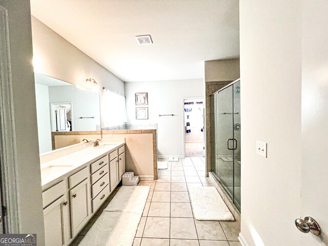 7860 Bristol Valley Dr, Cumming, GA 30028 - full bath featuring double vanity, a stall shower, and tile patterned flooring