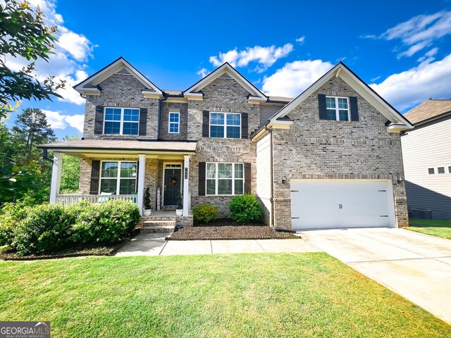 7860 Bristol Valley Dr, Cumming, GA 30028 - view of front facade with driveway, a front yard, a garage, and covered porch