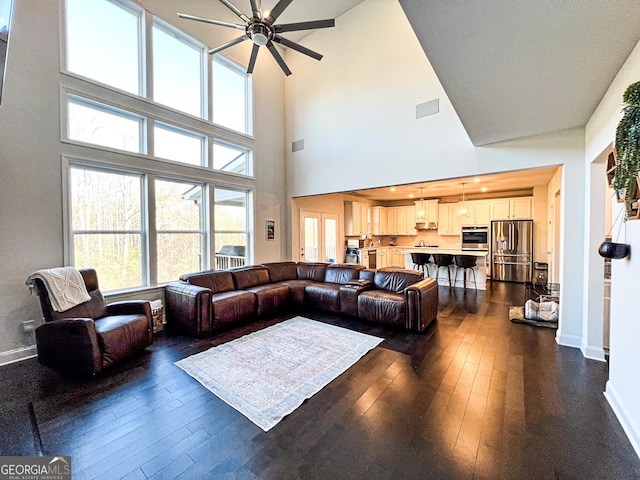 7860 Bristol Valley Dr, Cumming, GA 30028 - living area with a ceiling fan, dark wood finished floors, baseboards, and a high ceiling