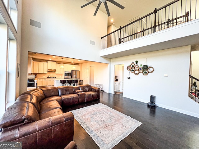 7860 Bristol Valley Dr, Cumming, GA 30028 - living room featuring a high ceiling, a ceiling fan, baseboards, and dark wood-style floors