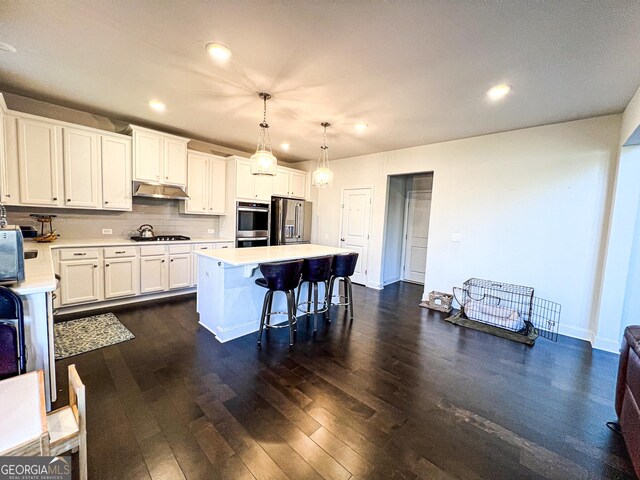 7860 Bristol Valley Dr, Cumming, GA 30028 - kitchen featuring stainless steel appliances, light countertops, recessed lighting, under cabinet range hood, and white cabinetry