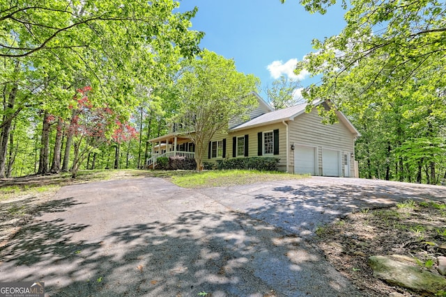 174 Leighs Xing, Cleveland, GA 30528 - view of front facade featuring driveway, a porch, and an attached garage