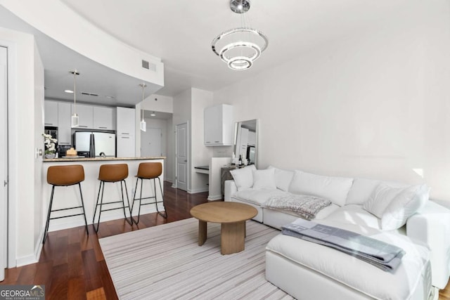 3324 Peachtree Rd NE Unit 1304, Atlanta, GA 30326 - living room featuring a chandelier, wood finished floors, and baseboards