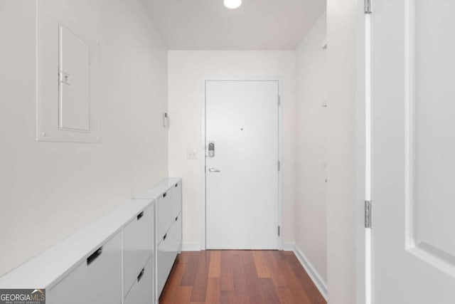 doorway featuring dark wood finished floors, baseboards, and recessed lighting