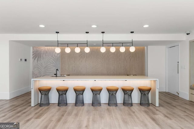 3324 Peachtree Rd NE Unit 1304, Atlanta, GA 30326 - kitchen with a sink, light wood-style floors, recessed lighting, baseboards, and decorative light fixtures