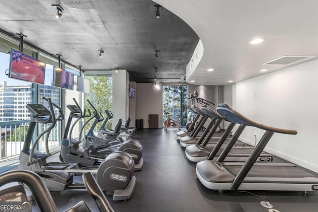 exercise room with recessed lighting and baseboards