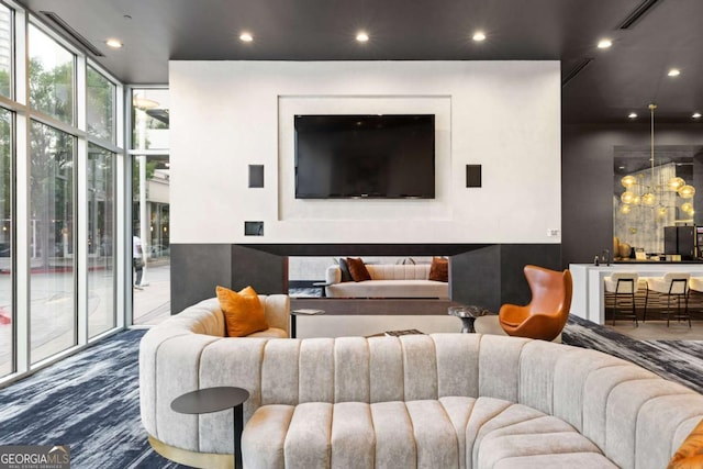common area with a wall of windows and recessed lighting