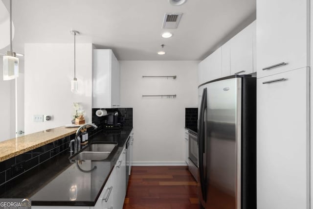 3324 Peachtree Rd NE Unit 1304, Atlanta, GA 30326 - kitchen featuring freestanding refrigerator, a sink, white cabinetry, dark wood-style floors, and dark stone countertops