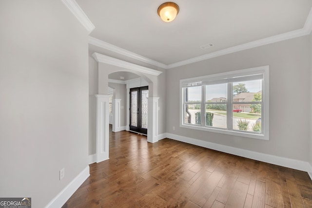 859 Heritage Lake Way, Grayson, GA 30017 - spare room with arched walkways, ornamental molding, baseboards, and dark wood-type flooring