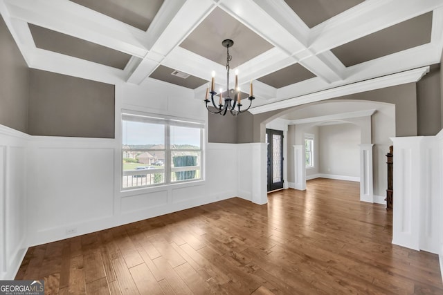 859 Heritage Lake Way, Grayson, GA 30017 - unfurnished dining area with arched walkways, a chandelier, coffered ceiling, wood-type flooring, and a decorative wall
