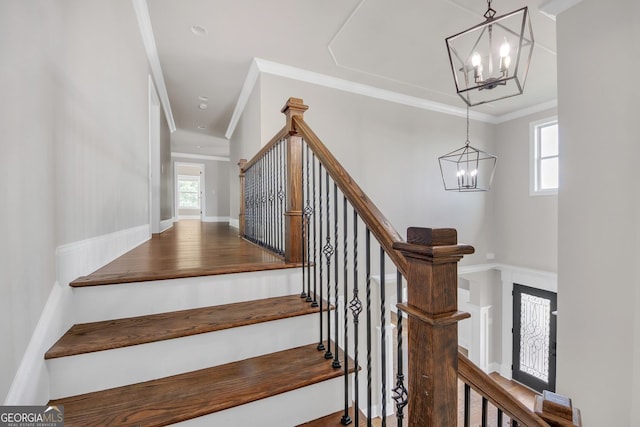 859 Heritage Lake Way, Grayson, GA 30017 - stairway with a chandelier, crown molding, wood finished floors, and baseboards