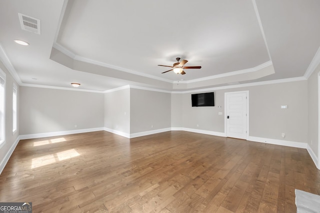 859 Heritage Lake Way, Grayson, GA 30017 - unfurnished living room featuring a raised ceiling, ceiling fan, hardwood / wood-style floors, baseboards, and crown molding