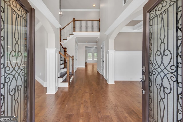 859 Heritage Lake Way, Grayson, GA 30017 - foyer with wood finished floors, crown molding, stairway, a towering ceiling, and arched walkways