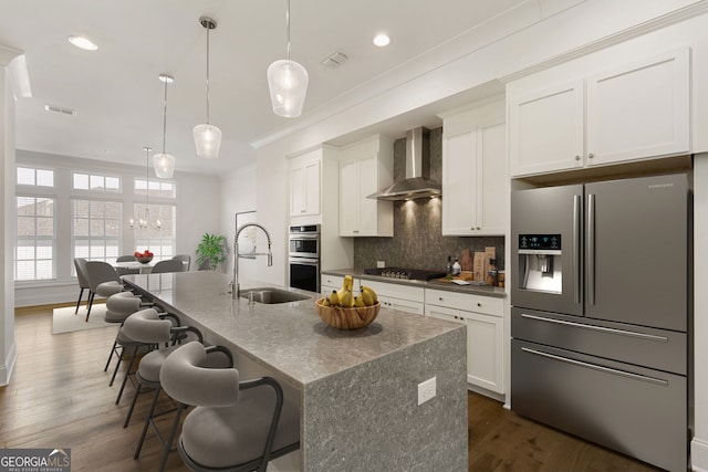6790 Encore Blvd, Sandy Springs, GA 30328 - kitchen with stainless steel appliances, wall chimney range hood, ornamental molding, backsplash, and white cabinets