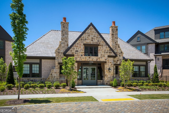 6790 Encore Blvd, Sandy Springs, GA 30328 - view of front of home with a chimney, french doors, and stone siding