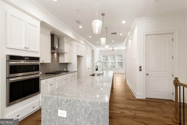 6790 Encore Blvd, Sandy Springs, GA 30328 - kitchen featuring stainless steel double oven, wall chimney range hood, white cabinets, crown molding, and decorative backsplash