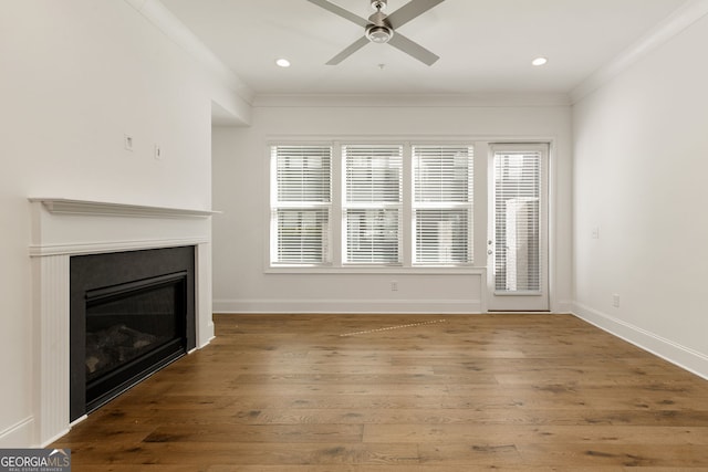 6790 Encore Blvd, Sandy Springs, GA 30328 - unfurnished living room with wood-type flooring, a glass covered fireplace, a ceiling fan, plenty of natural light, and recessed lighting