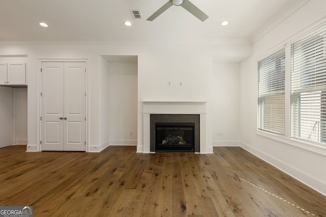 6790 Encore Blvd, Sandy Springs, GA 30328 - unfurnished living room featuring ceiling fan, wood-type flooring, a glass covered fireplace, recessed lighting, and crown molding