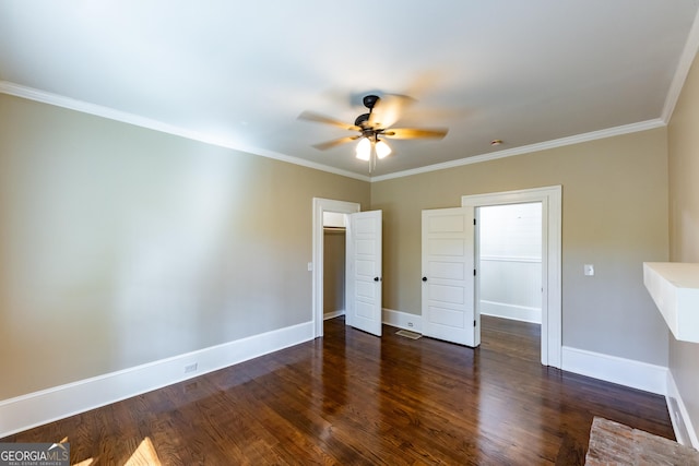 564 Bailey Mill Rd, Yatesville, GA 31097 - unfurnished bedroom featuring wood finished floors, crown molding, a walk in closet, a ceiling fan, and a closet