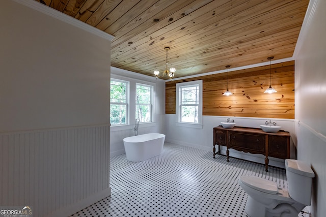 564 Bailey Mill Rd, Yatesville, GA 31097 - bathroom with wooden ceiling, wainscoting, a freestanding bath, a chandelier, and wood walls