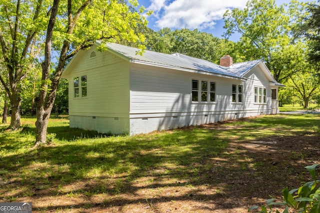 564 Bailey Mill Rd, Yatesville, GA 31097 - view of side of home with crawl space, a lawn, a chimney, and a metal roof
