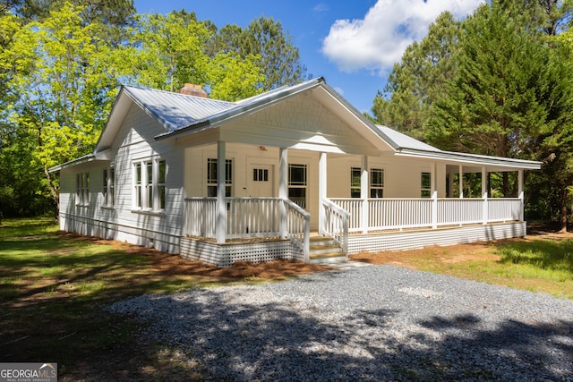 564 Bailey Mill Rd, Yatesville, GA 31097 - view of front facade featuring covered porch, a chimney, and a metal roof