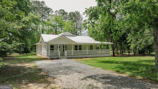 564 Bailey Mill Rd, Yatesville, GA 31097 - country-style home with covered porch, a metal roof, driveway, a chimney, and view of scattered trees