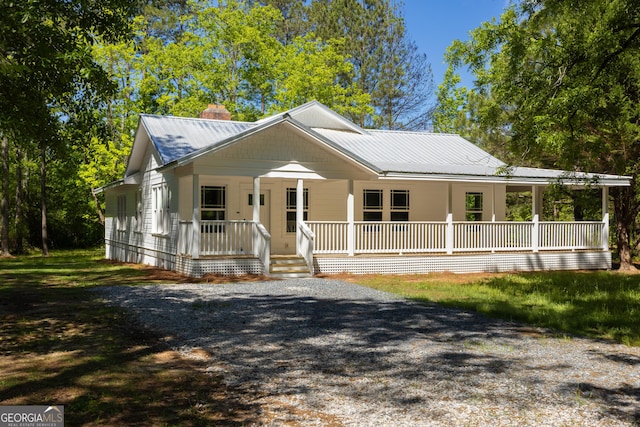 564 Bailey Mill Rd, Yatesville, GA 31097 - view of front of house with covered porch, a chimney, and a metal roof