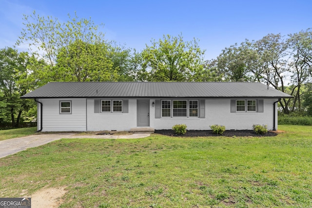 ranch-style house with metal roof, a front lawn, and brick siding