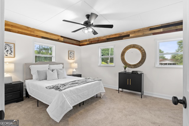bedroom with multiple windows, carpet flooring, and baseboards